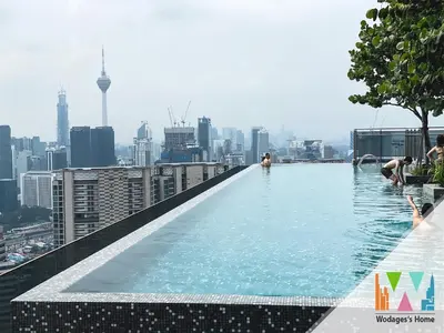 a infinity pool on the roof of a building with a city at Expressionz KLCC by Wodages in Kuala Lumpur