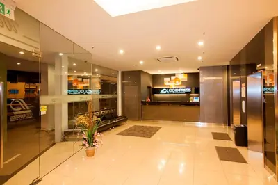 a lobby of a building with a potted plant at LEO Express Hotel in Kuala Lumpur
