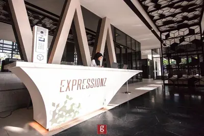 a woman sitting at a desk in a building at EXPRESSIONZ KLCC BY G Suites in Kuala Lumpur