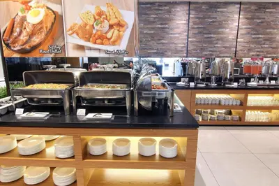 a food counter in a restaurant with some food at Pacific Express Hotel Chinatown in Kuala Lumpur