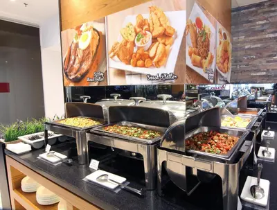 a buffet line with many different types of food at Pacific Express Hotel Chinatown in Kuala Lumpur