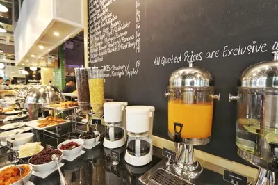 a counter with a bunch of food in a restaurant at Travelodge Kuala Lumpur City Centre in Kuala Lumpur