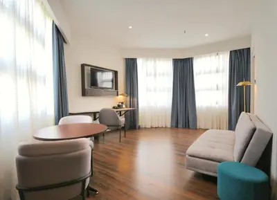 a living room with a couch and a table and chairs at Travelodge Kuala Lumpur City Centre in Kuala Lumpur