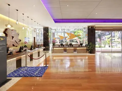 a lobby of a hotel with a reception desk at ibis Kuala Lumpur City Centre in Kuala Lumpur