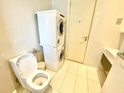 a bathroom with a toilet and a washing machine at KLCC Luxury Condo Damai 88 Near Gleneagles Hospital in Kuala Lumpur