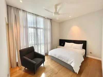 a bedroom with a bed and a chair and a window at KLCC Luxury Condo Damai 88 Near Gleneagles Hospital in Kuala Lumpur