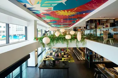 an overhead view of a lobby with a colorful ceiling at citizenM Kuala Lumpur in Kuala Lumpur