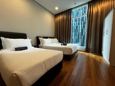 a hotel room with two beds and a large window at Soho Suites KLCC by Alucard's Cat in Kuala Lumpur
