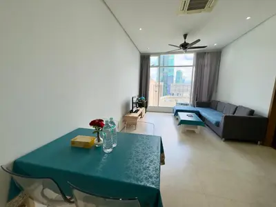a living room with a table and a couch at Soho Suites KLCC by Alucard's Cat in Kuala Lumpur