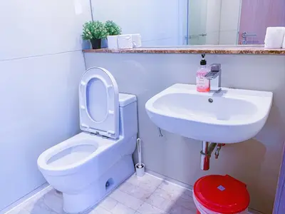 a bathroom with a white toilet and a sink at Soho Suites KLCC by Alucard\uff08\u5409\u9686\u5761KLCC Alucard Soho\u5957\u623f\u516c\u5bd3\uff09 in Kuala Lumpur