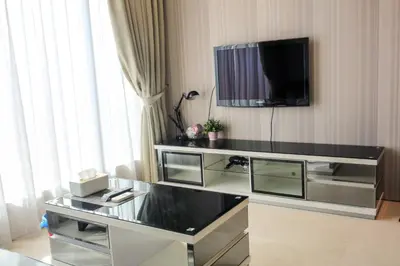 a living room with a tv on the wall at Soho Suites KLCC by Alucard\uff08\u5409\u9686\u5761KLCC Alucard Soho\u5957\u623f\u516c\u5bd3\uff09 in Kuala Lumpur