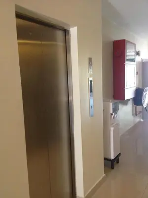 a metal elevator in a room with a refrigerator at Festival Boutique Hotel @ Kampung Pandan in Kuala Lumpur