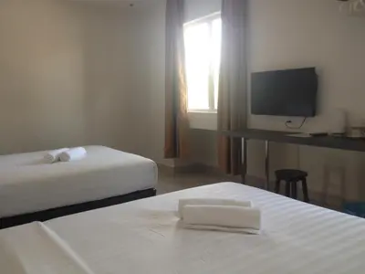 a hotel room with two beds and a television at Festival Boutique Hotel @ Kampung Pandan in Kuala Lumpur