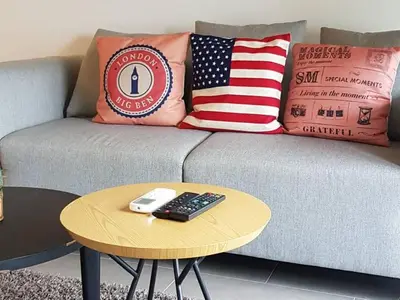 a couch with an american flag pillows and a table at The Establishment Bangsar in Kuala Lumpur