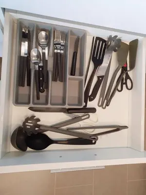 a drawer filled with utensils on a shelf at The Establishment Bangsar in Kuala Lumpur