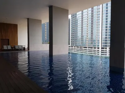 a swimming pool in a building with tall buildings at The Establishment Bangsar in Kuala Lumpur
