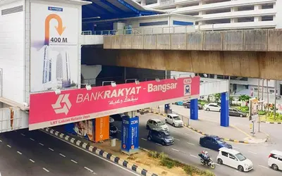 a bridge over a street with cars on the road at The Establishment Bangsar in Kuala Lumpur