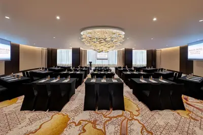 a ballroom with tables and chairs in a room with a chandelier at Pavilion Hotel Kuala Lumpur Managed by Banyan Tree in Kuala Lumpur