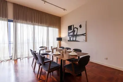 a dining room with a long table and chairs at The Mews KLCC by Plush in Kuala Lumpur