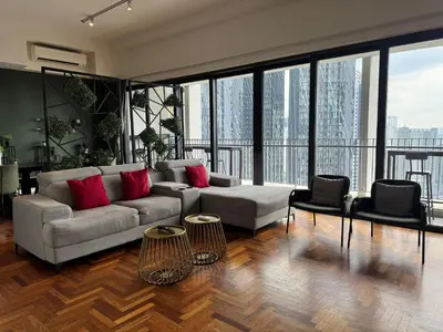 a living room with a couch and red pillows at The Mews KLCC by Plush in Kuala Lumpur