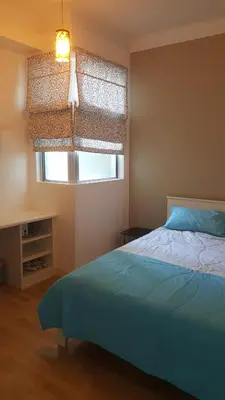 a bedroom with a blue bed and a window at 1room Publika in Kuala Lumpur