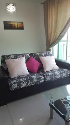 a black and white couch with three pillows on it at 1room Publika in Kuala Lumpur