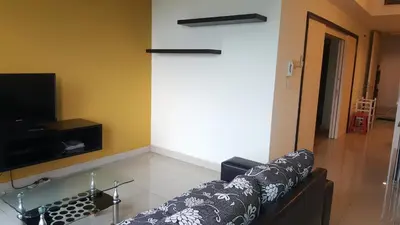 a living room with a couch and a tv at 1room Publika in Kuala Lumpur