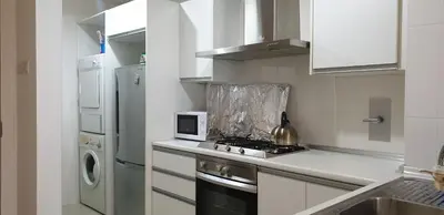 a small kitchen with a stove and a microwave at 1room Publika in Kuala Lumpur