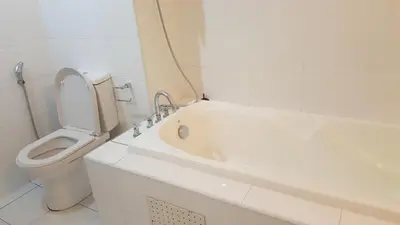a white bathroom with a toilet and a bath tub at 1room Publika in Kuala Lumpur