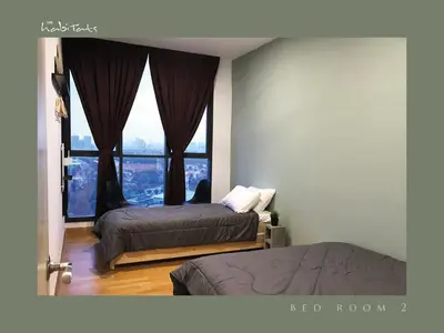 a bedroom with two beds and a large window at KL Gateway Mall - Easy Access to KL Sentral & KLCC in Kuala Lumpur