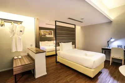 a hotel room with two beds and a desk at Days Hotel & Suites by Wyndham KL - Chan Sow Lin MRT or LRT in Kuala Lumpur