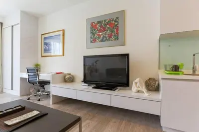 a living room with a television on a white cabinet at Perfect Location@ Heart of KL City Centre next to Metro MRT in Kuala Lumpur