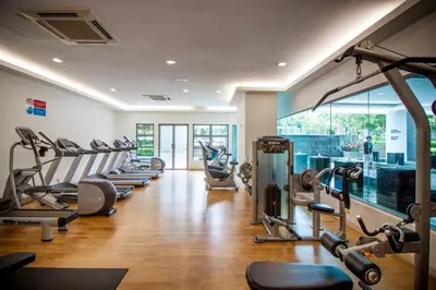 a gym with a row of treadmills and machines at Suasana Bukit Ceylon by Plush in Kuala Lumpur