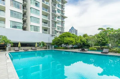 a swimming pool in front of a building at Suasana Bukit Ceylon by Plush in Kuala Lumpur