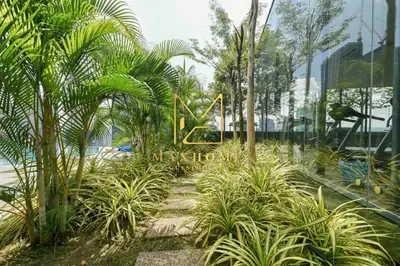 a sign for a resort with palm trees and a pool at Maxhome@Dorsett Residence , KL in Kuala Lumpur