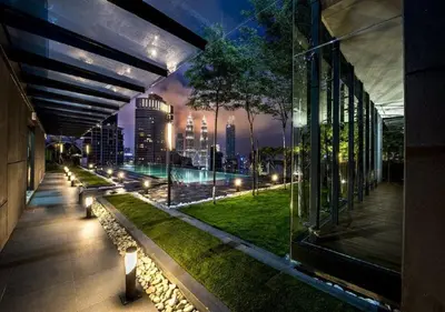 a building with a view of a city at night at Maxhome@Dorsett Residence , KL in Kuala Lumpur