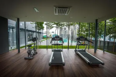 a gym with three treadmills and a large window at Maxhome@Dorsett Residence , KL in Kuala Lumpur
