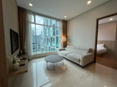 a living room with a couch and a table and a large window at Soho Suites KLCC in Kuala Lumpur