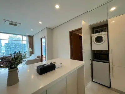 a kitchen with a counter with a washer and dryer at Soho Suites KLCC in Kuala Lumpur