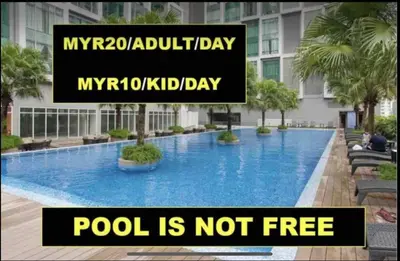a sign that says my holiday pool is not free at Soho Suites KLCC in Kuala Lumpur