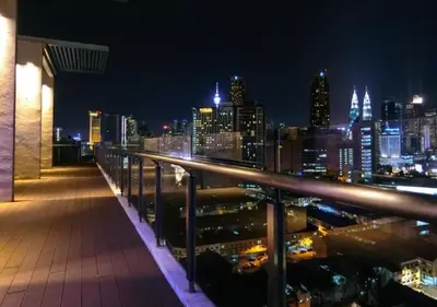 a view of a city skyline at night at Maxhome @ D'Majestic Place, KL City Centre in Kuala Lumpur