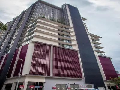 a large tall building with red and white at Maxhome @ D'Majestic Place, KL City Centre in Kuala Lumpur