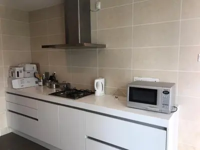 a kitchen with a stove and a microwave on a counter at Avenue K in Kuala Lumpur