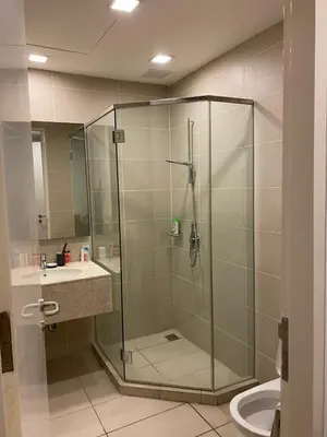 a bathroom with a shower and a sink and a toilet at Avenue K in Kuala Lumpur