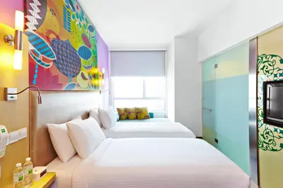 a hotel room with two beds and a tv at Ibis Styles Kuala Lumpur Fraser Business Park in Kuala Lumpur