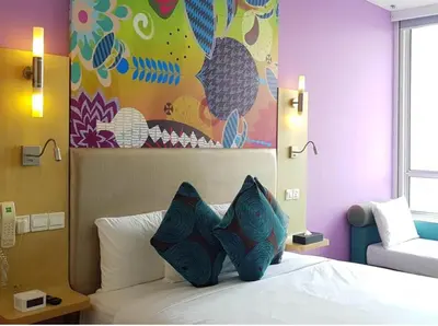 a bedroom with a bed with a painting on the wall at Ibis Styles Kuala Lumpur Fraser Business Park in Kuala Lumpur