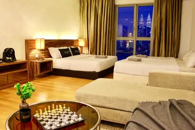 a hotel room with two beds and a chess board at ✦Time & Traveller✦Regalia Suites and Residence✦KLCC view Infinity Pool✦双子塔无边泳池 in Kuala Lumpur
