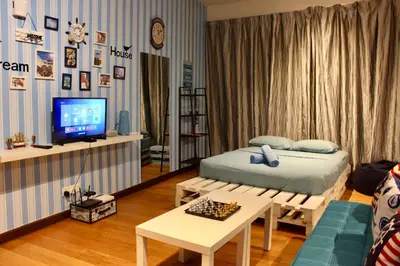 a room with a bed and a table and a tv at ✦Time & Traveller✦Regalia Suites and Residence✦KLCC view Infinity Pool✦双子塔无边泳池 in Kuala Lumpur