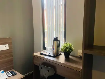 a table with a coffee maker and a window at Asia Like Boutique Hotel in Kuala Lumpur