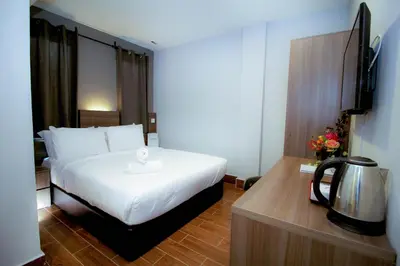 a hotel room with a bed and a television at Asia Like Boutique Hotel in Kuala Lumpur
